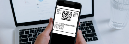 UDI als QR-Code auf dem Handy vor Laptop